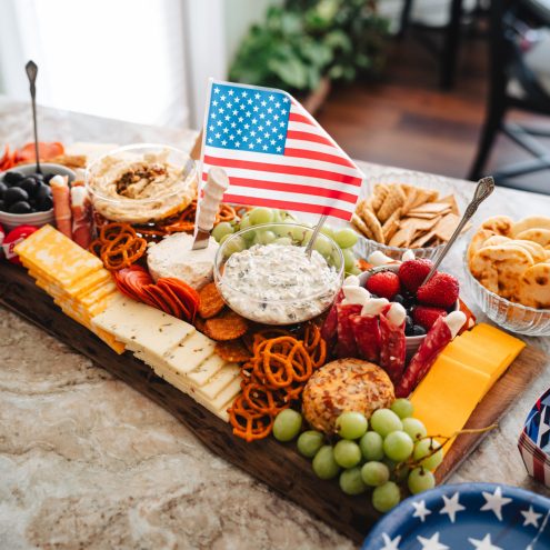 Patriotic charcuterie board with American flag and snacks